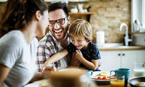 A line of credit can helps everyday needs young family laughing at kitchen table