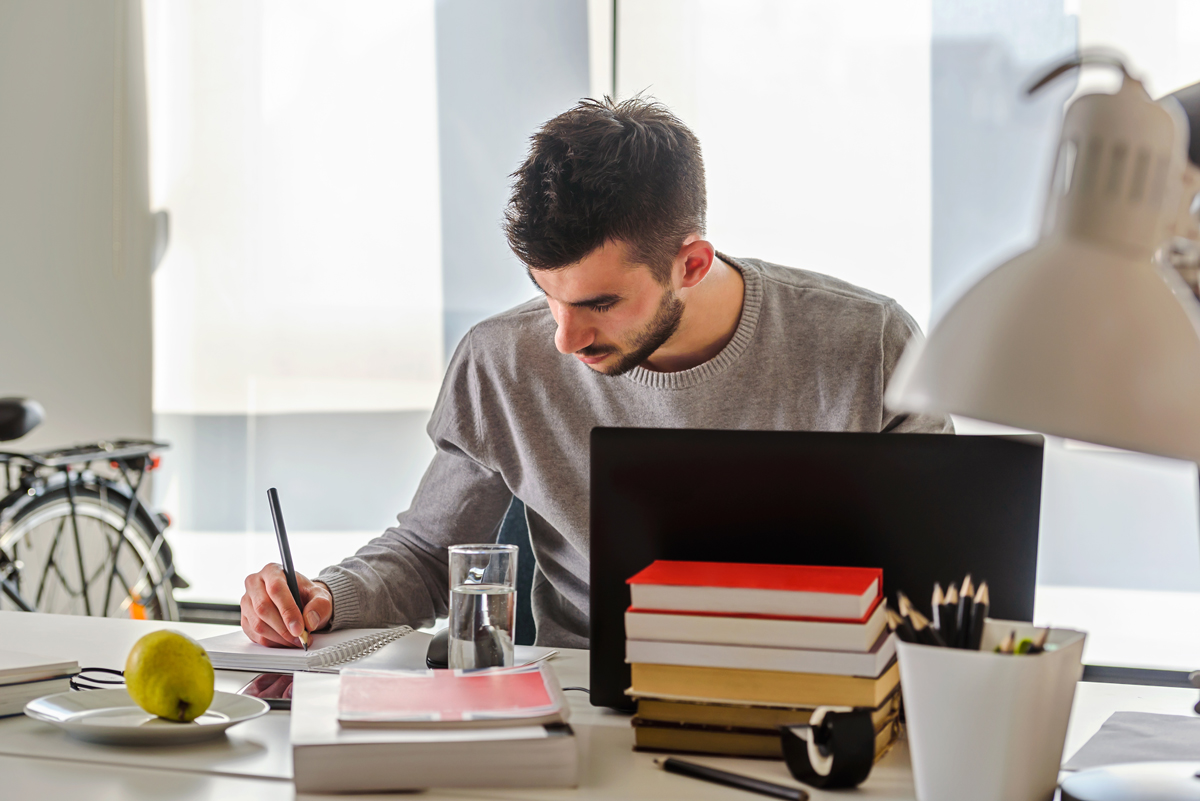 Student Chequing man on laptop
